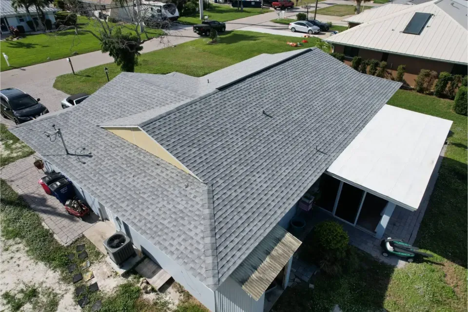 Drone view of a complete residential asphalt shingle roof replacement in Lee County, showcasing high-quality, storm-resistant craftsmanship by Legrand's Roofing.
