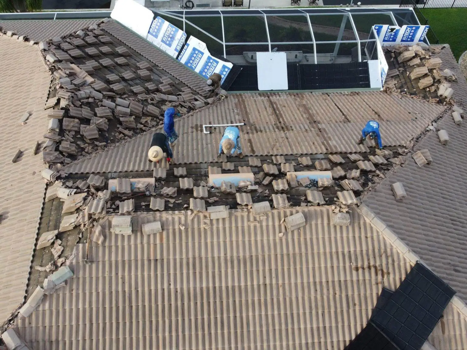 Drone view capturing the extensive concrete tile removal process on the 217 residential re-roofing project by Legrand's Roofing.