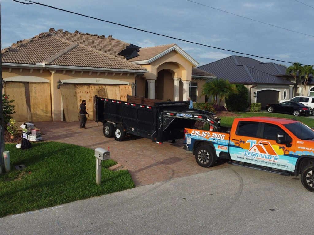 Legrand’s roof repair contractor and dump trailer outside a Florida home during residential tile roof repair.