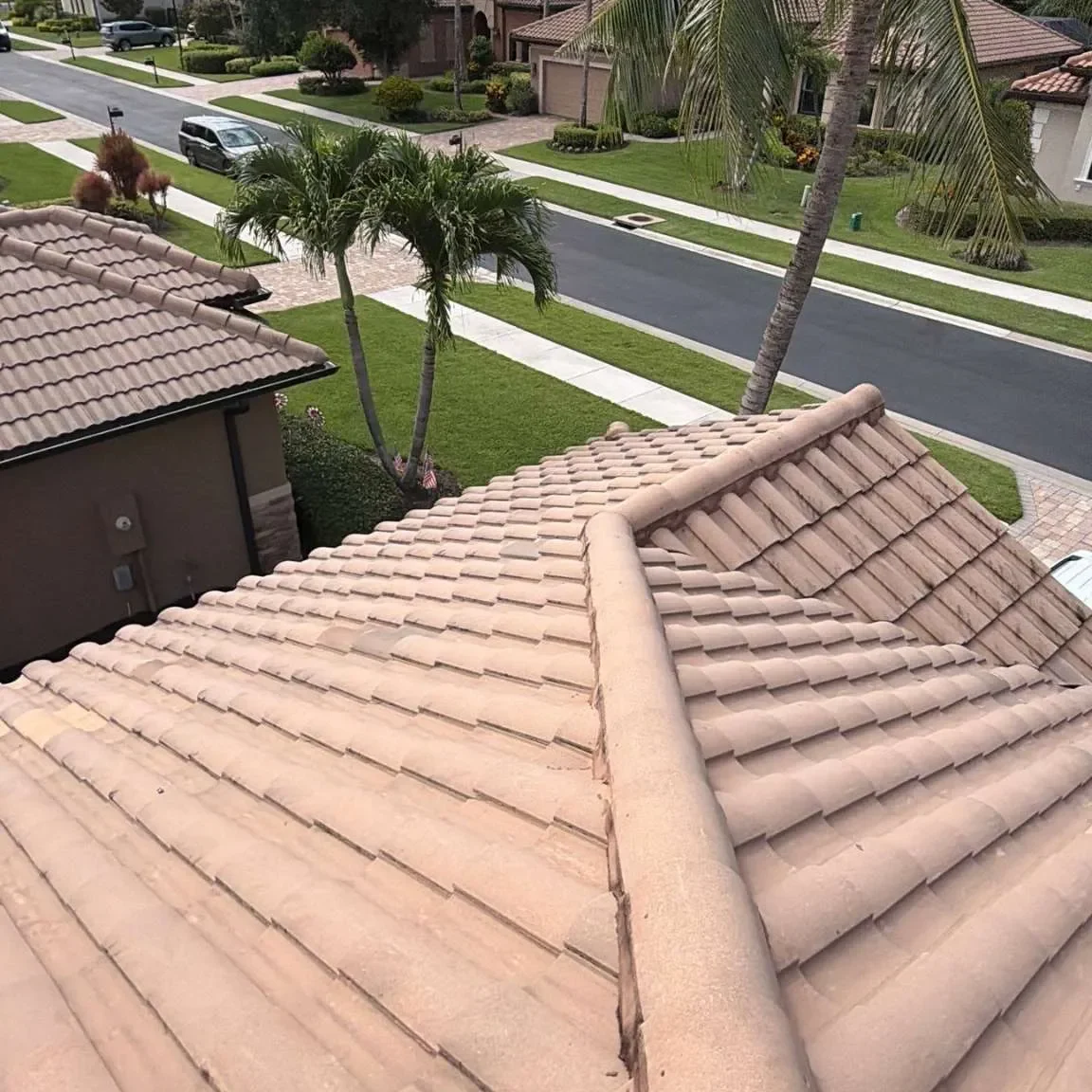 High-angle overview showcasing the clean, uniform rows and perfectly aligned hip ridge cap tiles completed during the Sally Craft roof repair project.
